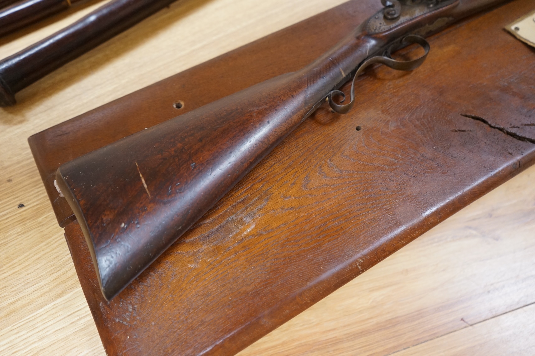 A single barrel flintlock sporting gun by Manton, half stocked, with signed lock and rainproof pan, platinum lined vent, and iron furniture (worn smooth)